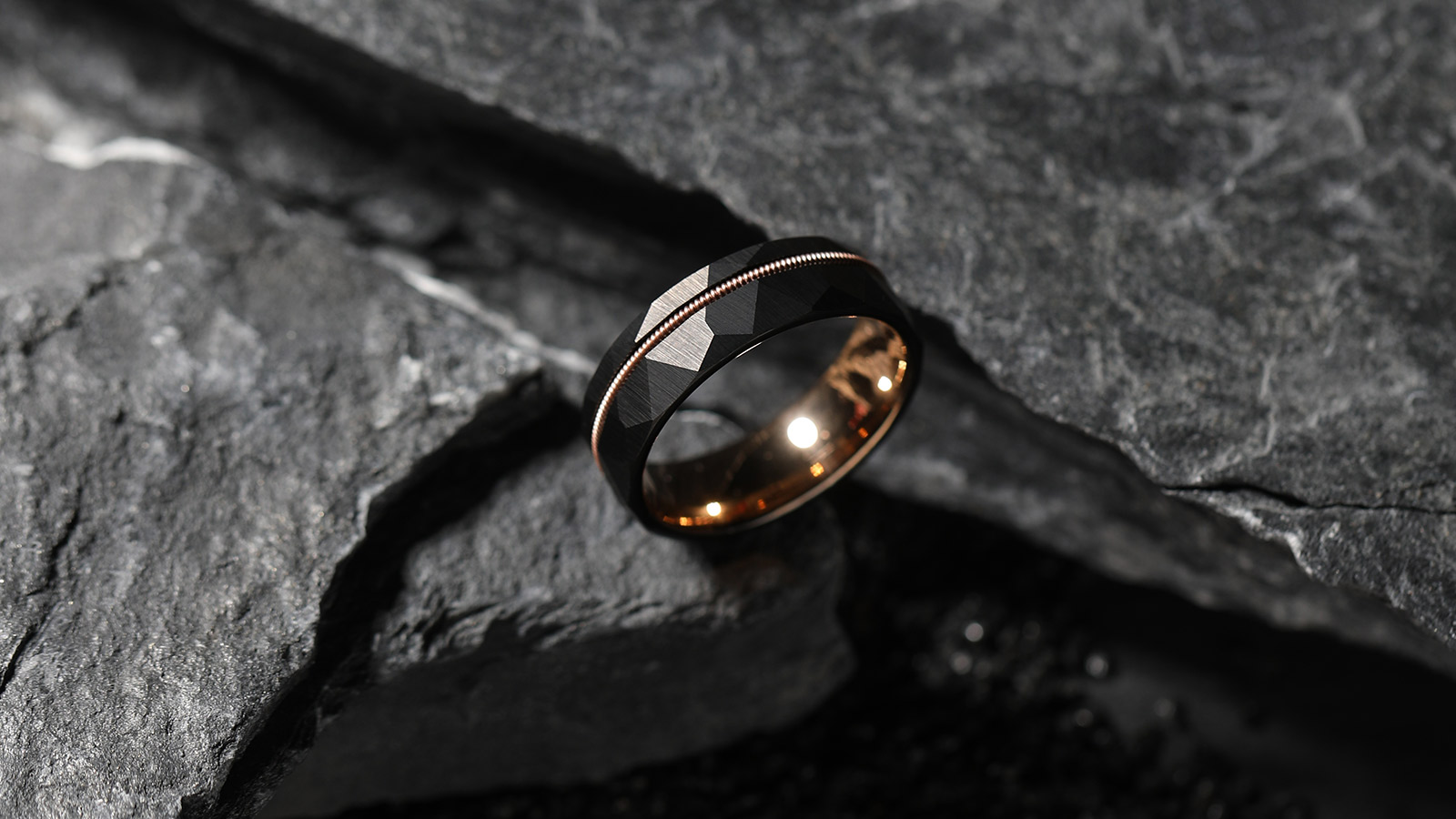 A elegant black tungsten wedding ring with stone background