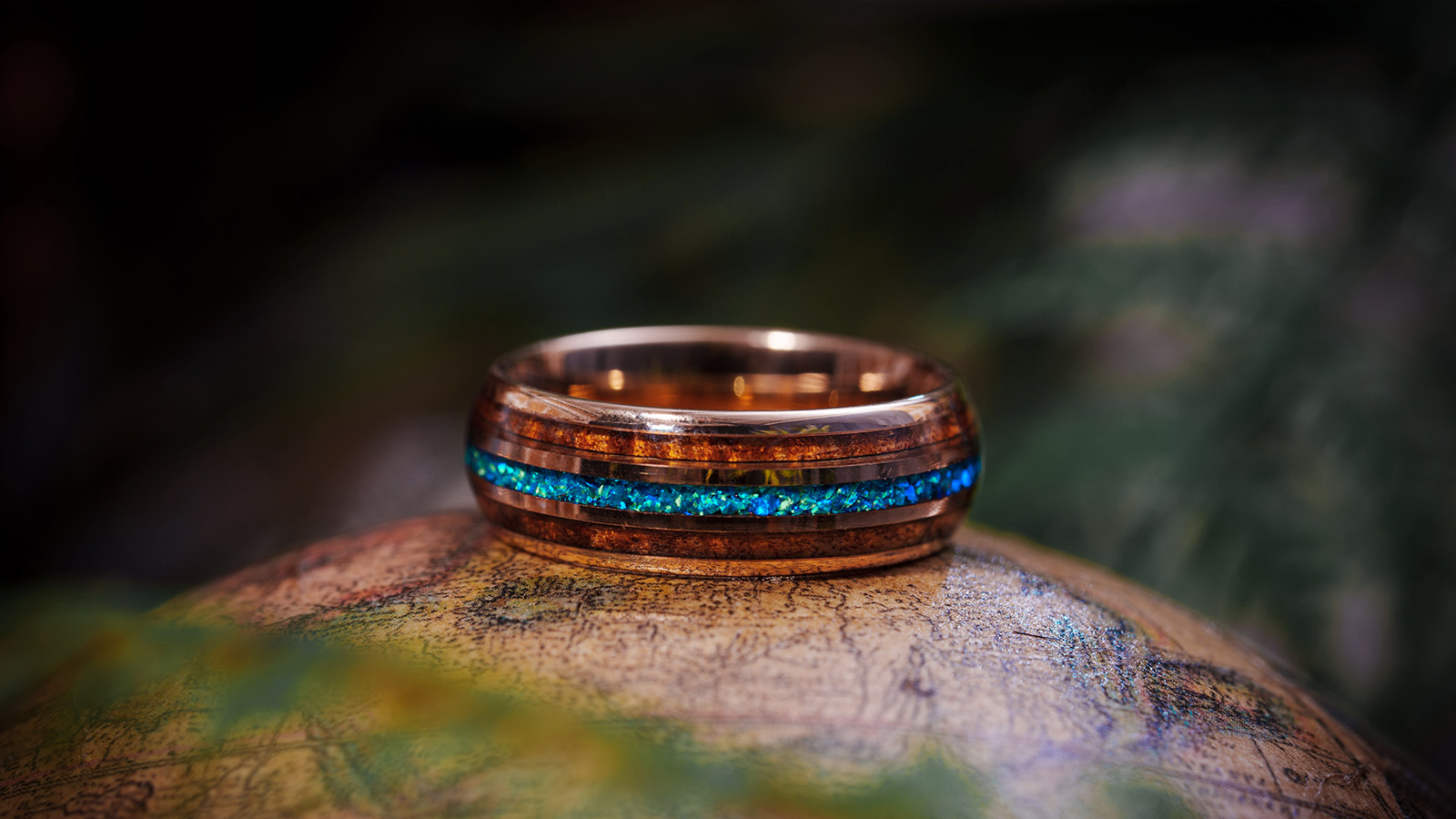 Brown classic men's ring with a teal setting in the middle, mysterious and elegant