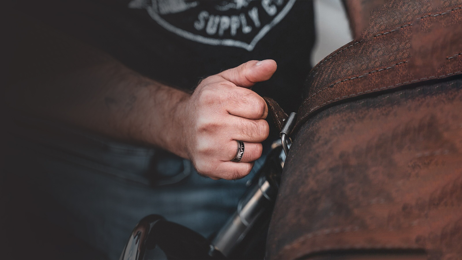 A man wears a black wedding ring at work